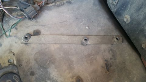 1985 Ford Bronco - Close-up view of an underhood bracket with associated wiring and mounting bolts.