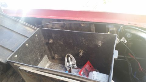 1985 Ford Bronco - Close-up of an underhood toolbox containing tools and other items.