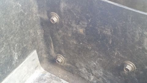 1985 Ford Bronco - A close-up view of a black plastic underhood toolbox, showing its textured surface and mounting bolts.