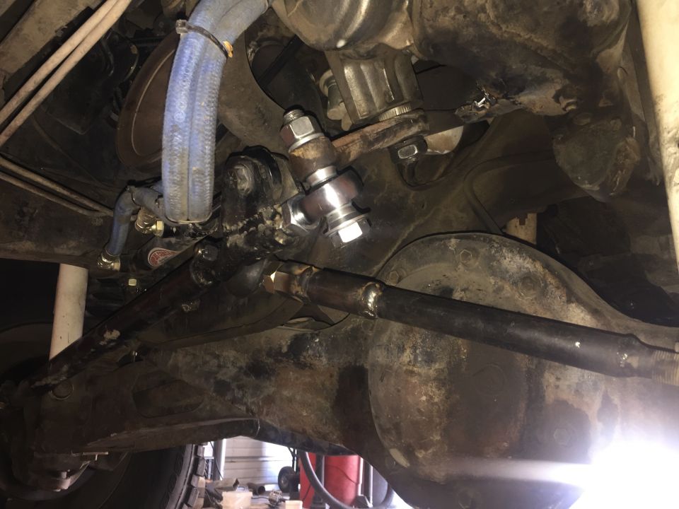 close-up of vehicle steering linkage and suspension components