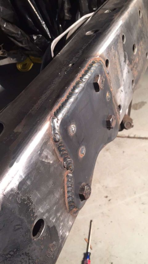 1979 Ford Bronco - A close-up view of a vehicle frame shows extensive welding and bolts, with visible rust.