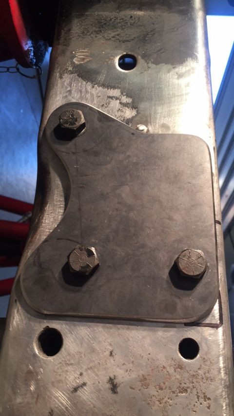1979 Ford Bronco - Close-up of a custom metal bracket attached to a vehicle's frame, likely for a suspension modification.