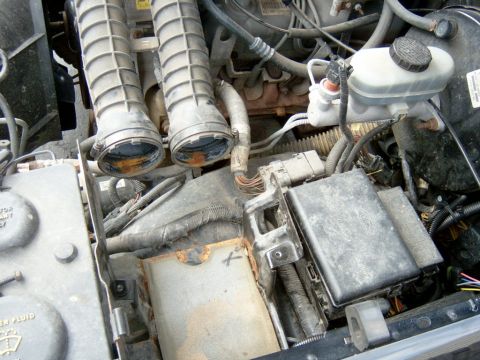 1995 Ford Bronco - Air box and breather tube removed. I had to cut the hose off of the oil fill spout to get the tube off.