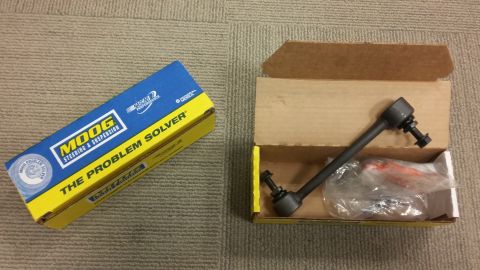 2000 Pontiac Grand Prix - A Moog steering and suspension part, labeled "THE PROBLEM SOLVER," is shown next to its open cardboard box. The part is a dark gray metal r…