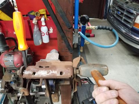 1995 Ford F-150 - With a prybar on the other end keeping the lever tight to the box, smack the nut's face to drive the shaft's splines out of the lever.