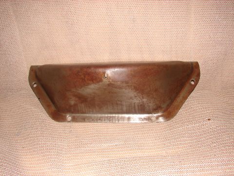 1973 Ford Ranchero - A rusty, metal, trapezoidal-shaped part with mounting holes is shown against a textured fabric background. The part appears to be a fender…