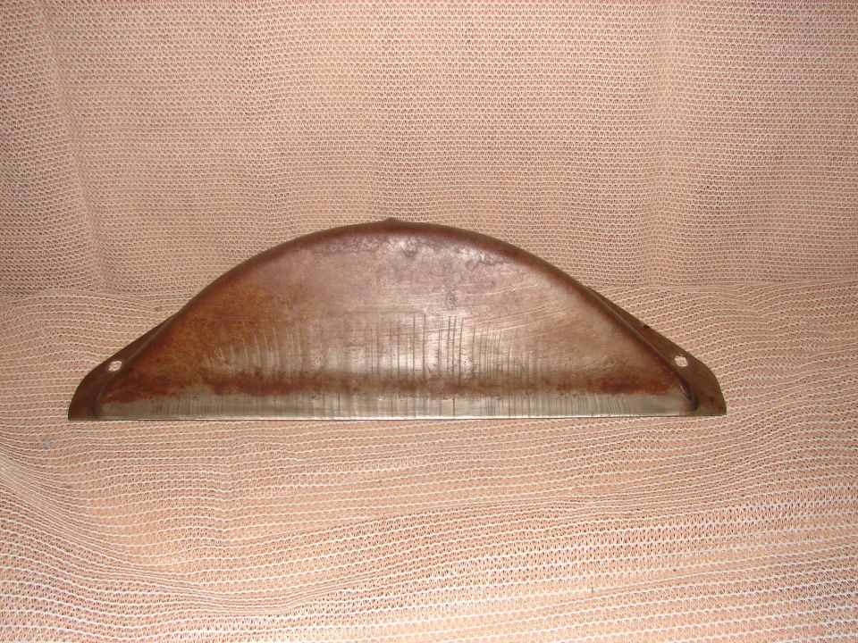 Curved metallic part with rust and striations