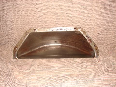 1973 Ford Ranchero - A rusted metal oil pan is shown from a top-down perspective, resting on a textured fabric surface. The pan has several mounting holes aroun…