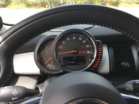 2001 Ford Crown Victoria - The interior of a car shows a close-up of the steering wheel and instrument cluster. The digital display shows a "Door open" warning.