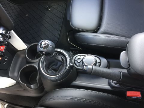 2001 Ford Crown Victoria - Interior view of a manual transmission shift knob and center console in a car. The shift knob displays the gear pattern for a 6-speed manua…