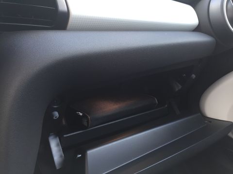 2001 Ford Crown Victoria - The interior of a car's glove compartment is shown, with a dark-colored wallet resting inside. The compartment door is open, revealing the…