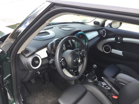 2001 Ford Crown Victoria - The interior of a modern car, likely a Mini Cooper, is shown from the passenger side, looking towards the driver's seat and dashboard. Visi…