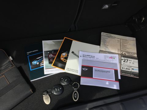 2001 Ford Crown Victoria - A collection of car documents and keys are laid out on a dark surface. The documents include owner's manuals, a battery log form, and a fue…