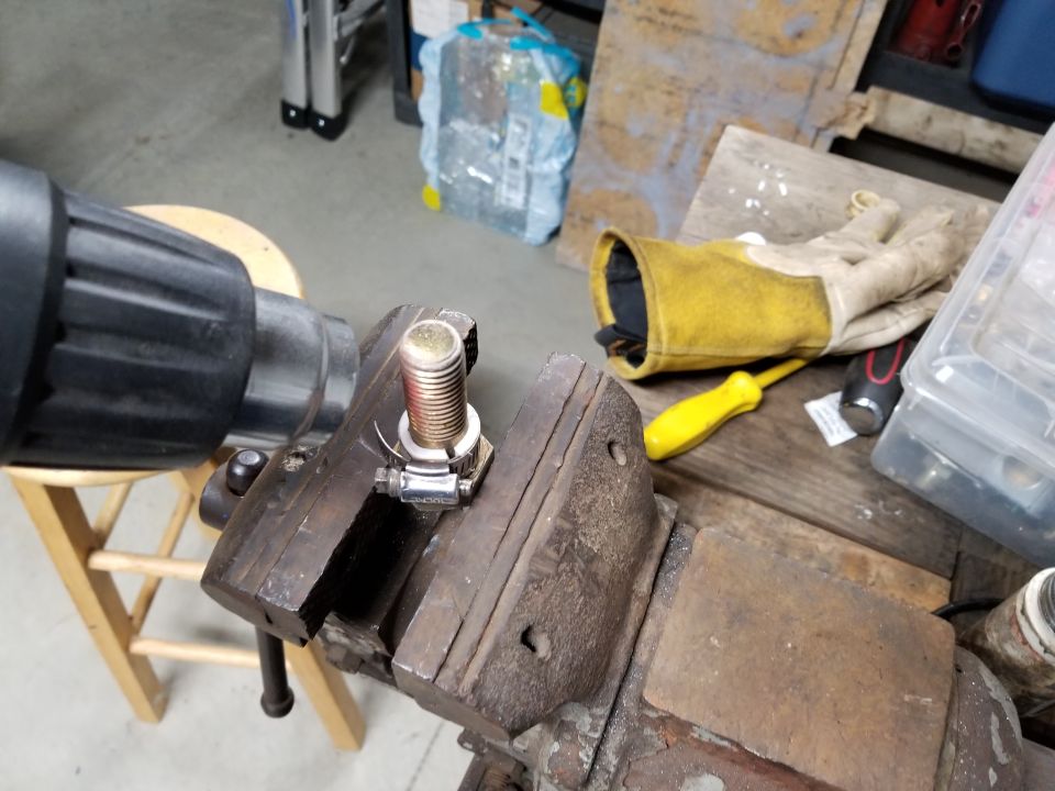 Using this bolt as a mold makes the bushing rounder than using the hose clamp alone.  I preheated the bolt, and heated it longer this time before chilling, due to the greater thermal mass.  It came out about as smoothly- & tightly-curved as the old bushing, but it's thicker, and made of better plastic ([url=https://www.amazon.com/dp/B00CPRELXI/]Teflon[/url]).