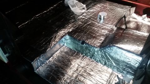 1968 Ford Bronco - The interior floor of a vehicle is covered in reflective sound deadening material. The material is cut and applied to the contours of the f…