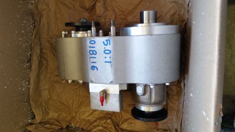 1968 Ford Bronco - A silver gearbox with blue markings '9118116' and '5.0:1' is shown in a cardboard box lined with brown paper. A small red fitting is visibl…