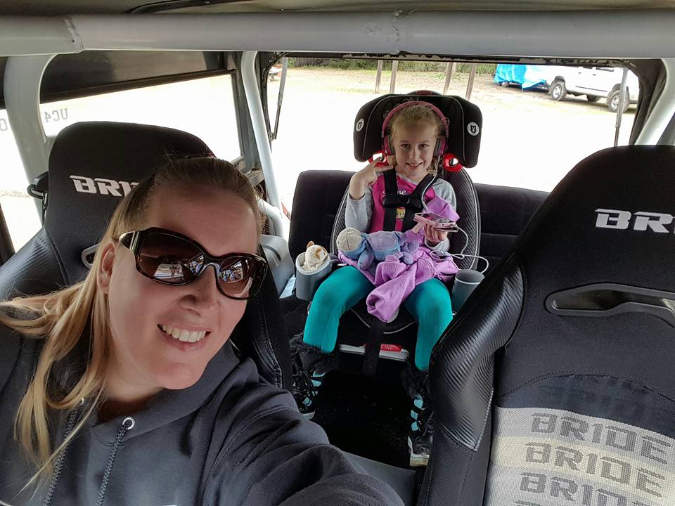Woman and child in a modified off-road vehicle.