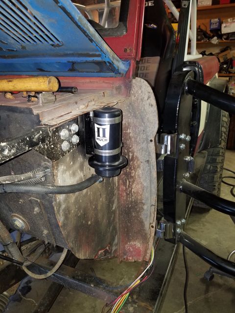 1968 Ford Bronco - A black fluid catch can with a white logo is mounted to the firewall of a vehicle. The vehicle appears to be a project build with exposed m…