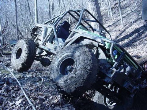 1992 Ford Bronco - This heavily modified buggy is deep in the woods, stuck in mud and leaves.