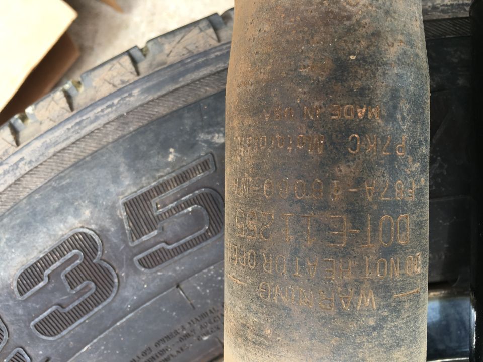 Tire sidewall with "35" and shock absorber with "DOT-E11250", "MADE IN USA"