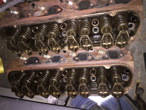 1996 Ford Bronco - This is a close-up, overhead view of two V8 engine cylinder heads, likely removed from a vehicle. The components visible include spark plug…