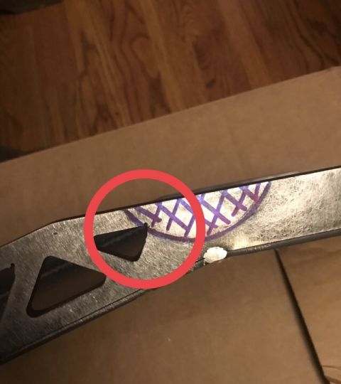 1995 Ford Bronco - A close-up shot shows a metallic part of a vehicle, possibly a ski or a blade, with purple crosshatch markings and a small black triangular…