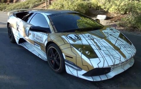 1992 Ford Bronco - A white and gold Lamborghini with a custom Star Wars-themed wrap is parked on an asphalt road with greenery in the background.