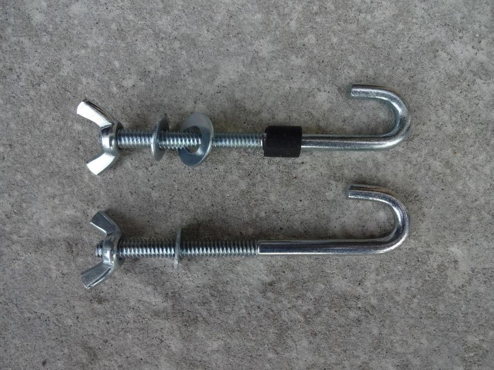 Two metal J-hook bolts with wing nuts and washers on concrete.