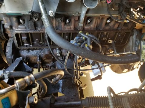 1995 Ford F-150 - Lifting the upper radiator hose let the cover slip out the front.