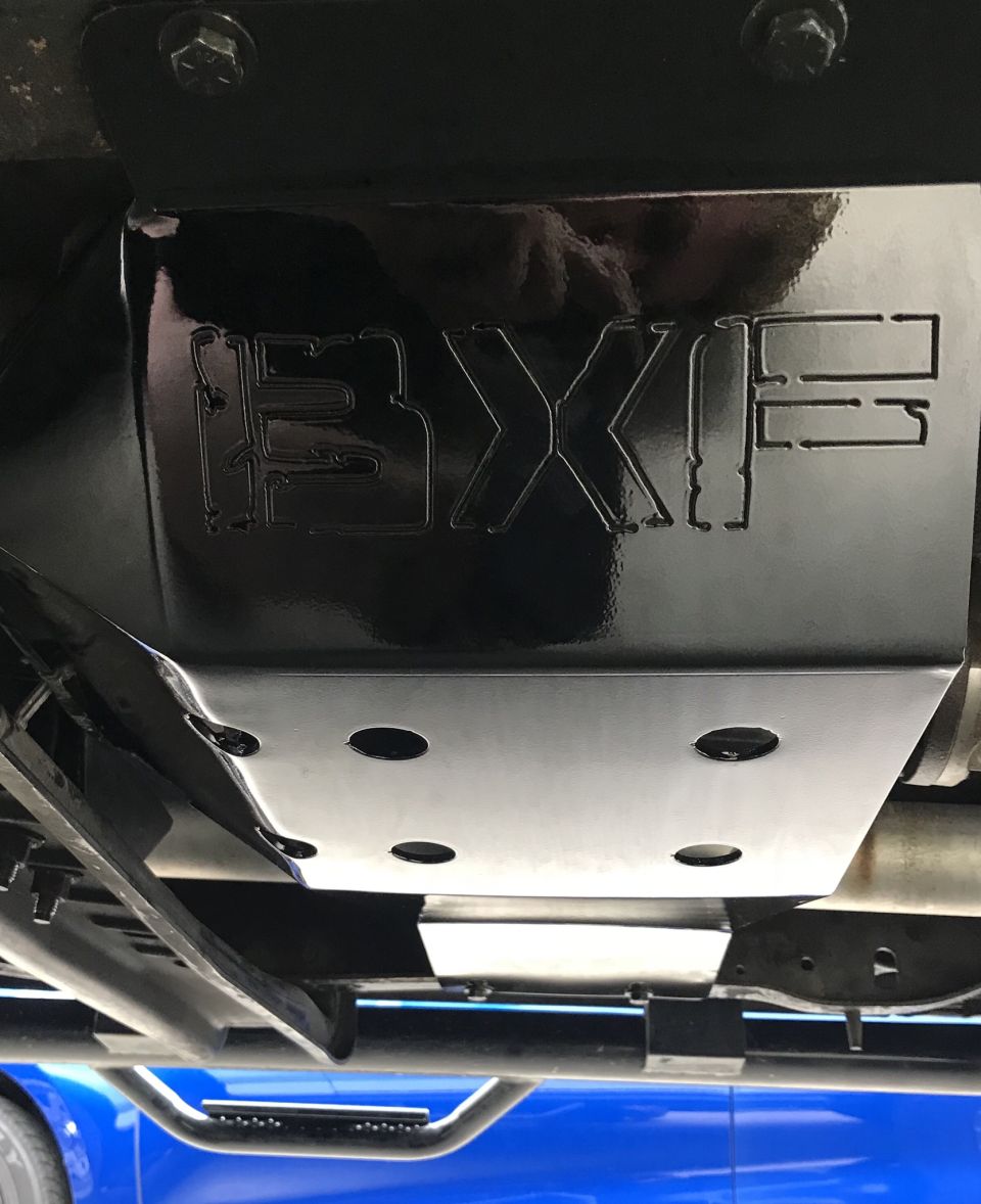 Close-up of a black BXF skid plate mounted under a vehicle.