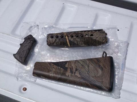 1995 Mercury Grand Marquis - Camouflage gun stock and forend parts are shown, packaged separately on a white surface.