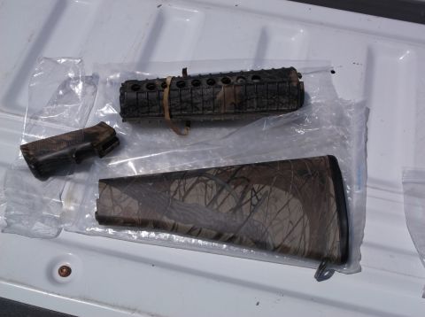1995 Mercury Grand Marquis - Camouflage gun stock and forend parts are shown on a white surface.