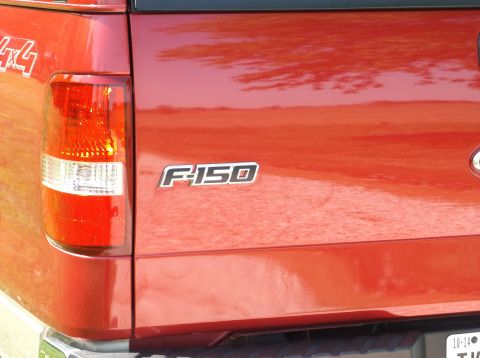 2008 Ford F-150 - Rear view of a red Ford F-150 pickup truck, showing the tailgate and taillight.