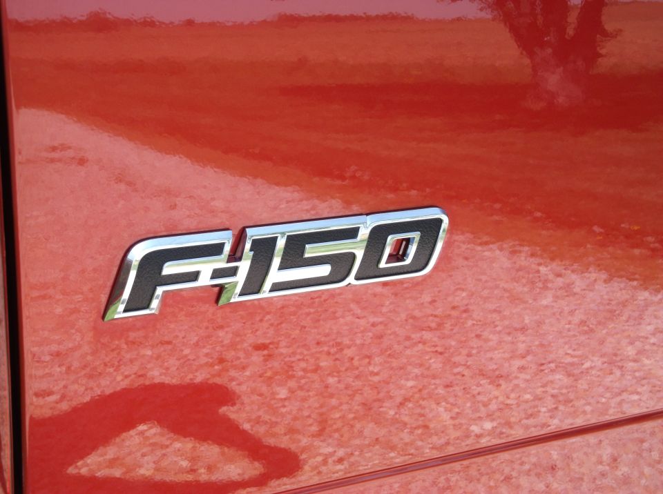 Close-up of F-150 emblem on a red truck
