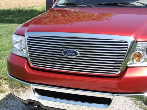2008 Ford F-150 - Front view of a red Ford F-150 pickup truck, showing its distinctive grille and headlights.