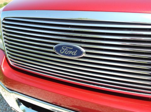 2008 Ford F-150 - The chrome grille and Ford logo are visible on the front of a red truck.