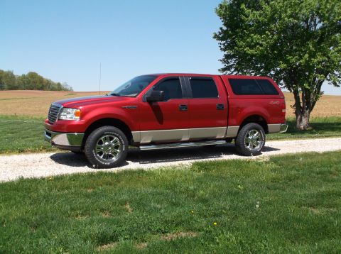 2008 Ford F-150 - Red Ford F-150 pickup truck with a tan lower body and a matching cap parked outside.