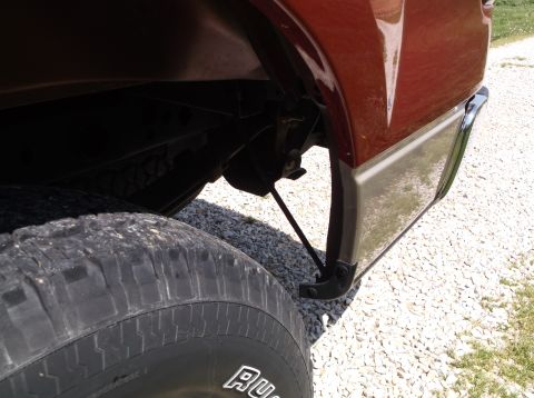 2008 Ford F-150 - Close-up view of the rear wheel and lower body panel on a red 2008 Ford F-150.