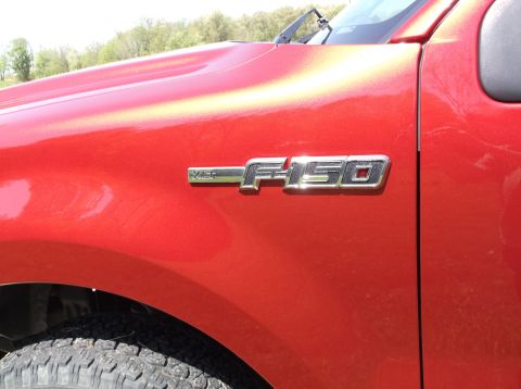 2008 Ford F-150 - The F-150 badge is clearly visible on the fender of this red truck.