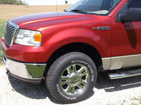 2008 Ford F-150 - Front quarter view of a red Ford F-150 truck, showing the grille and badge.