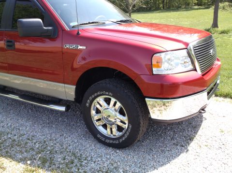 2008 Ford F-150 - Red Ford F-150 truck with chrome accents parked on a gravel lot.