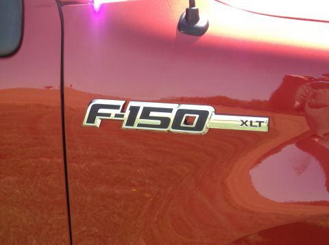 2008 Ford F-150 - The F-150 XLT badge is clearly visible on the side of the red truck.