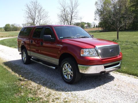 2008 Ford F-150 - This red Ford F-150 pickup truck features a camper shell and a two-tone paint scheme.