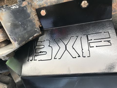 1989 Ford Bronco - Close-up of a vehicle's undercarriage, showing a custom skid plate with brand markings.