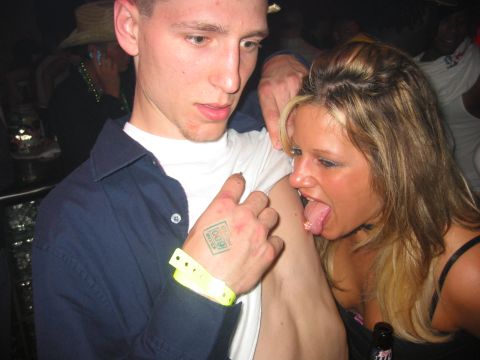 1989 Ford Bronco - A tattoo on a person's hand is visible at a party.