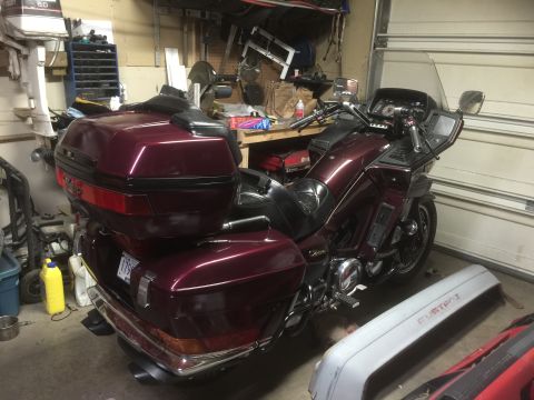 1983 Yamaha Venture - A maroon touring motorcycle is parked in a garage, with tools and other items visible in the background.