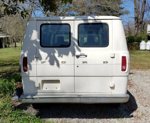 1971 Ford Ranchero - This white Ford van is seen from the rear, barn doors and a chrome bumper.