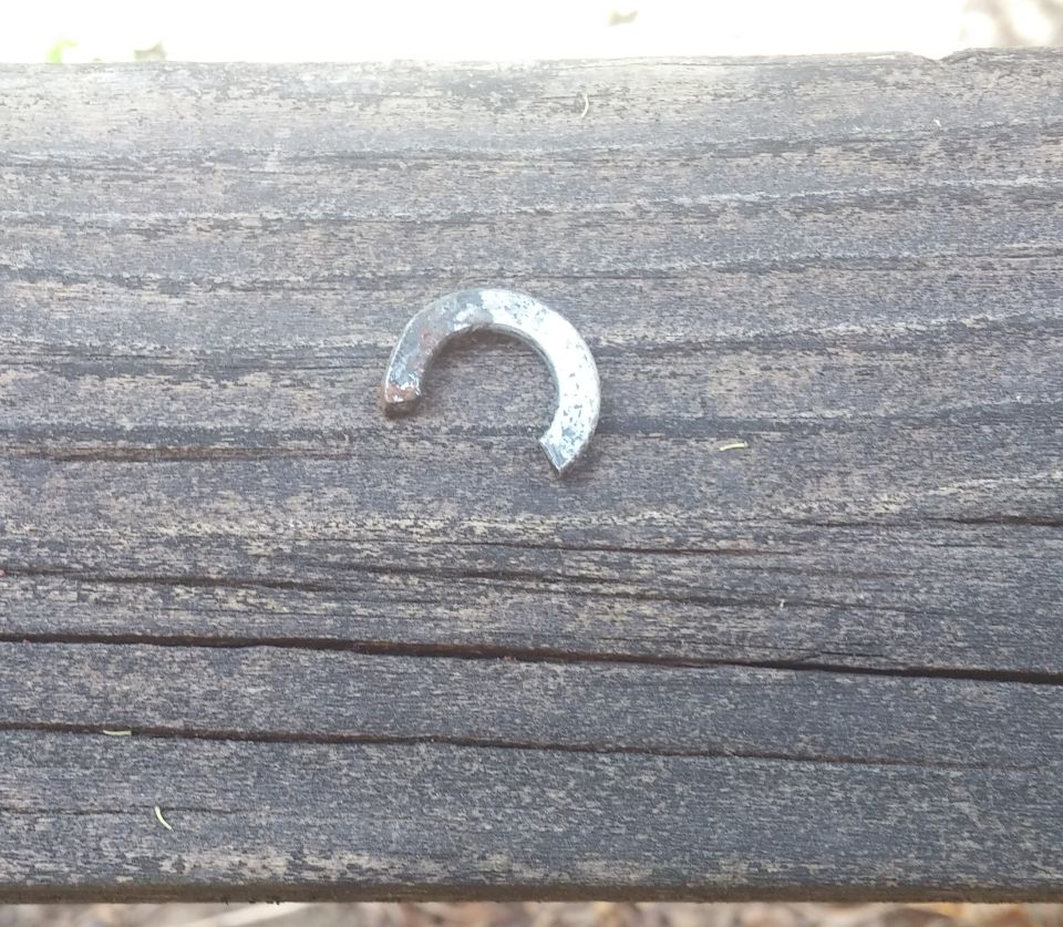 Split washer on weathered wooden surface