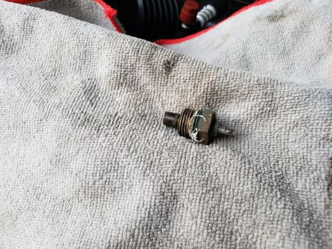 1989 Ford Bronco - A close-up of a vehicle's engine sensor, placed on a towel for examination.