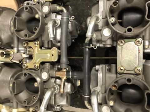1983 Yamaha Venture - A pair of motorcycle carburetors are shown in a close-up view, with visible hoses and fittings.